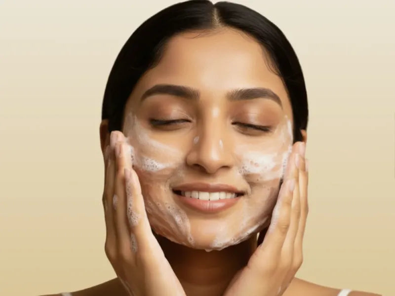 Woman applying a facial mask with a beige background